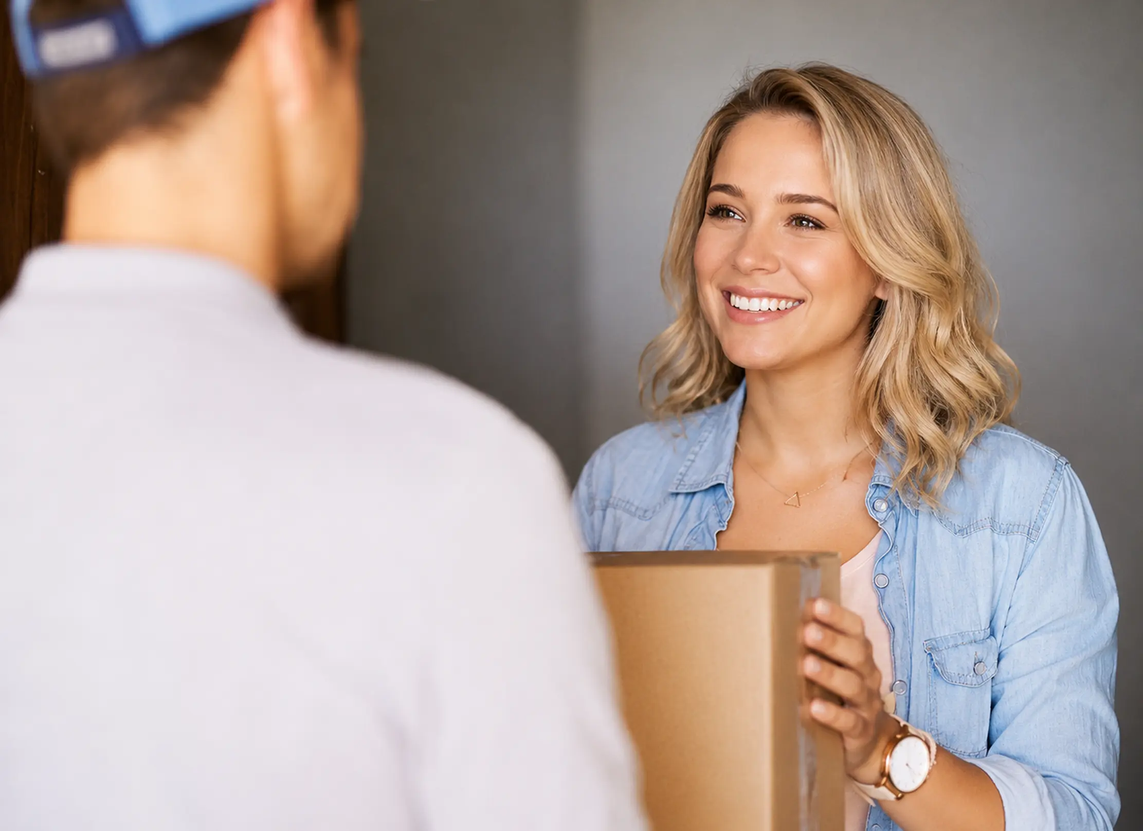 Delivery person handing package to smiling customer